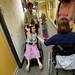 Michigan fan Emily Lickman, 7, of South Lyon, smiles as she looks to high-five friend Kaitlin Barrett-Huff, 11, of Ann Arbor, in the hallway outside of the radio booth. The two were selected to speak on air with their mothers as part of the Mott Takeover at 1050 WTKA on Friday, May 17, 2013. Melanie Maxwell I AnnArbor.com
